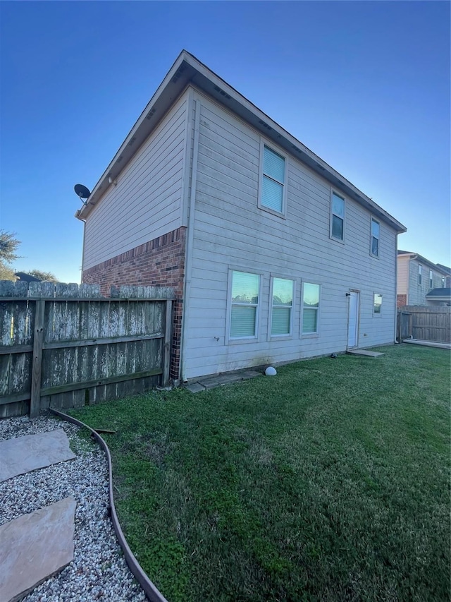 rear view of property featuring a yard