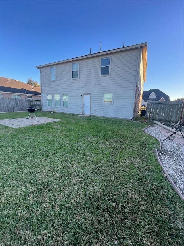 back of property featuring a patio and a lawn