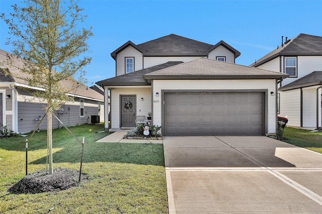 view of front of property with a garage and a front lawn