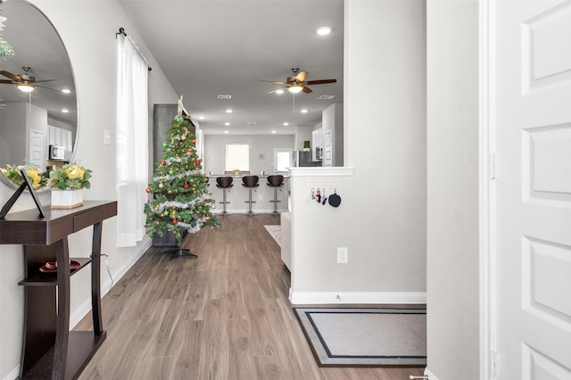 corridor with light hardwood / wood-style floors