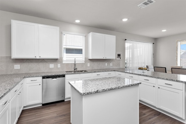 kitchen with white cabinets, dishwasher, and sink