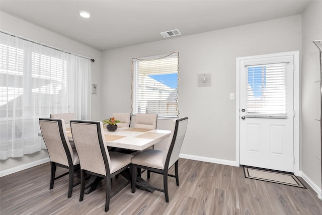 dining space with hardwood / wood-style flooring