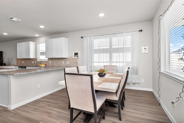 dining area with hardwood / wood-style flooring and sink