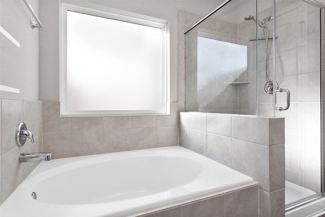 bathroom featuring separate shower and tub and plenty of natural light