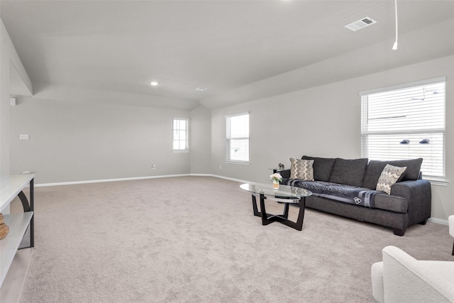 carpeted living room featuring lofted ceiling