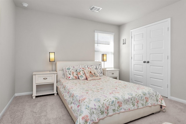 bedroom featuring light carpet and a closet