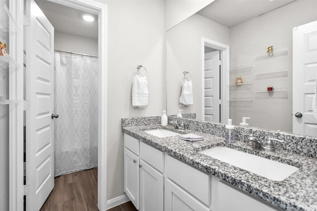 bathroom featuring a shower with shower curtain, vanity, and wood-type flooring