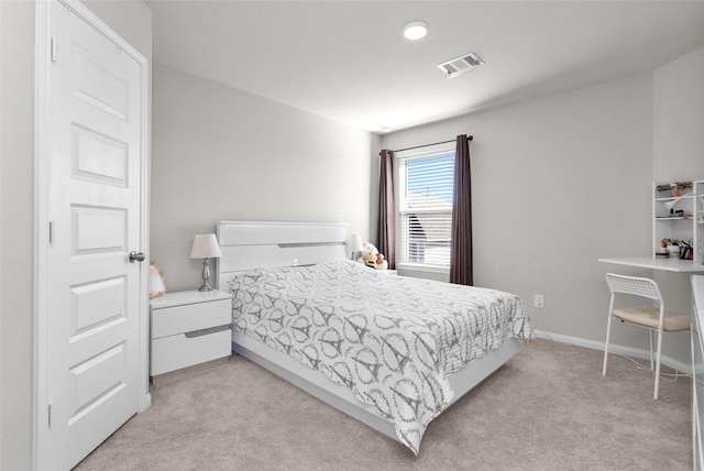 bedroom featuring light carpet