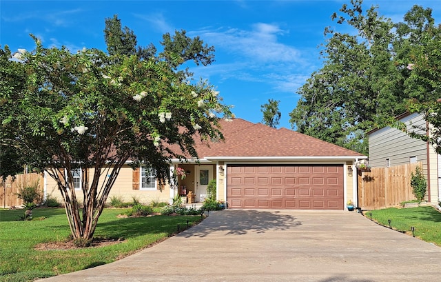 view of front of property with a front lawn and a garage