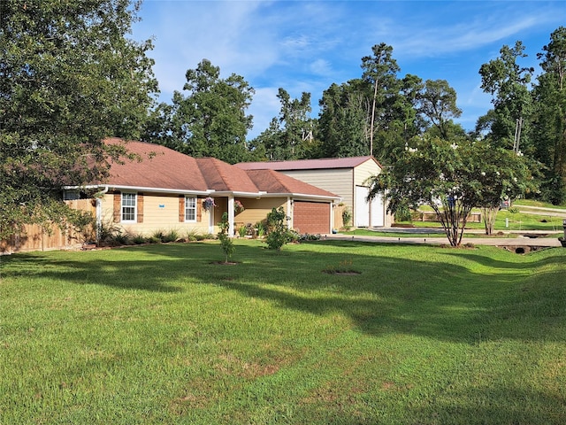 single story home featuring a front yard and a garage