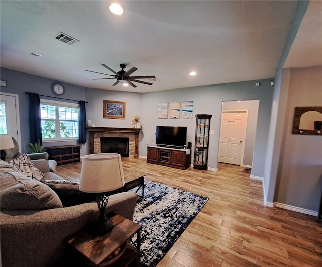 living room featuring ceiling fan and light wood-type flooring