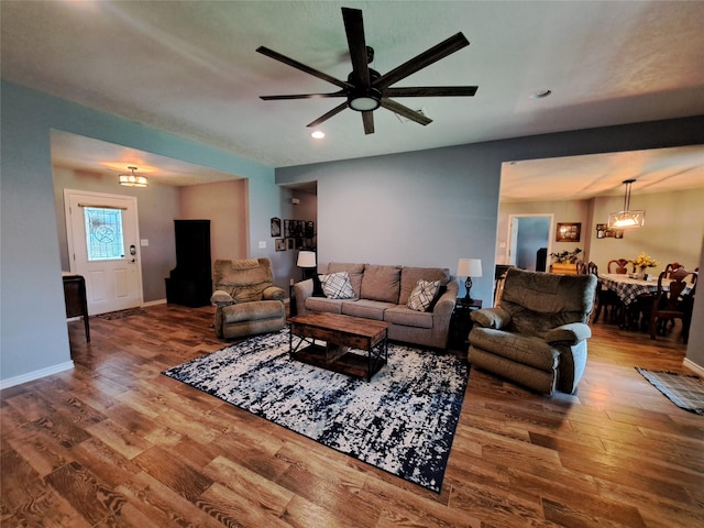 living room featuring hardwood / wood-style flooring and ceiling fan