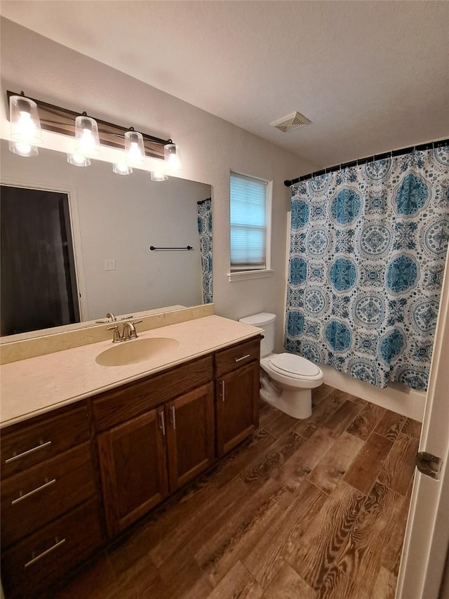 bathroom featuring wood-type flooring, vanity, and toilet