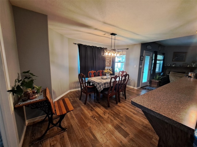 dining room with a chandelier and dark hardwood / wood-style floors