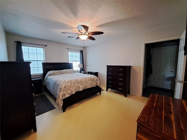 bedroom featuring a textured ceiling and ceiling fan