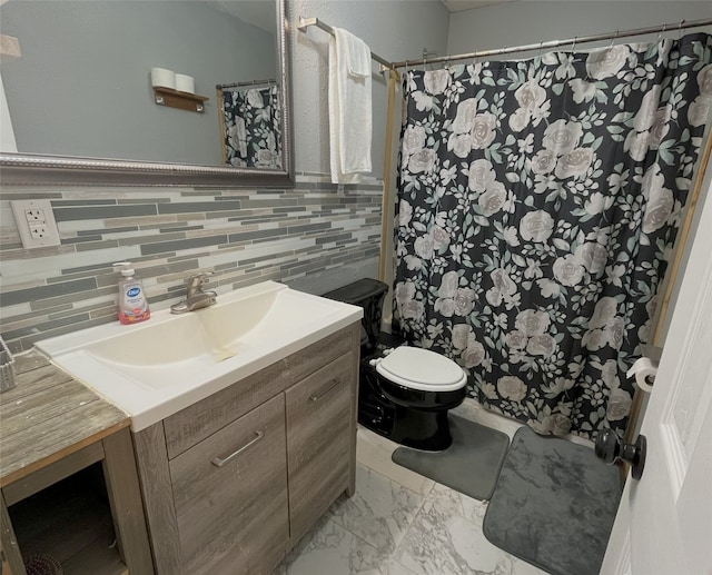 bathroom with vanity, toilet, and tasteful backsplash