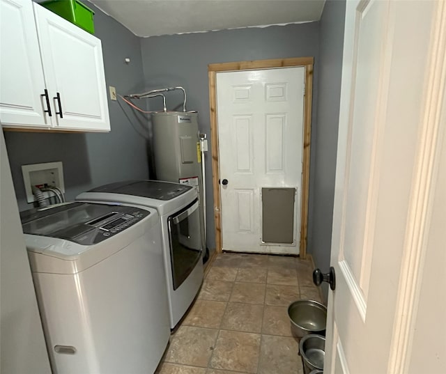 laundry room with cabinets, independent washer and dryer, and water heater