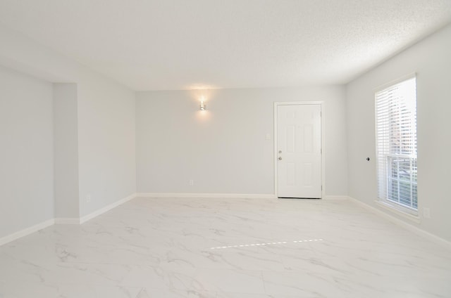 spare room with a textured ceiling