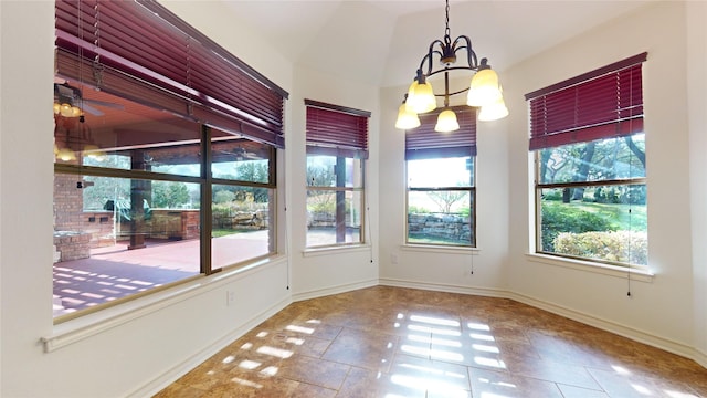 unfurnished dining area featuring ceiling fan with notable chandelier, tile patterned floors, and vaulted ceiling