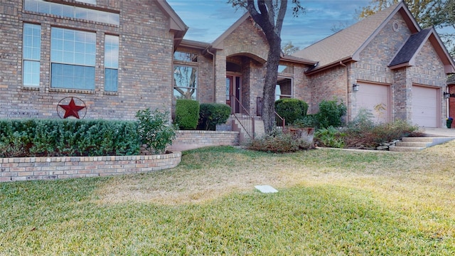 view of front of home with a front yard and a garage