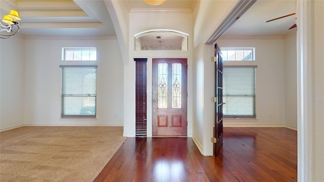 entryway featuring crown molding, a towering ceiling, ceiling fan, and dark hardwood / wood-style floors