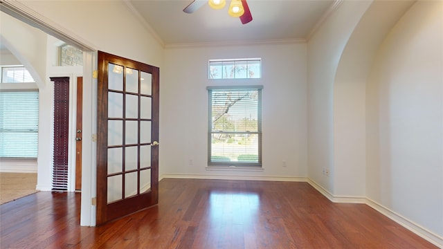 empty room featuring french doors, vaulted ceiling, ceiling fan, dark hardwood / wood-style floors, and ornamental molding