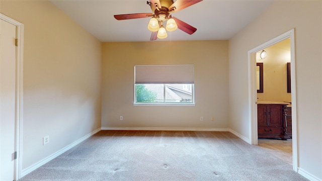 unfurnished bedroom featuring ensuite bath, ceiling fan, and light carpet