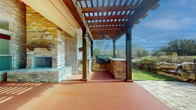 view of patio with ceiling fan and an outdoor stone fireplace