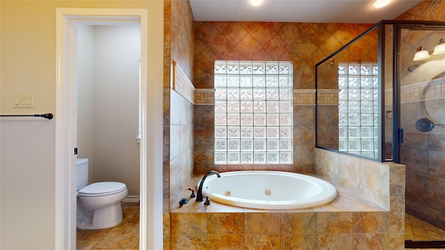 bathroom with tile patterned flooring, shower with separate bathtub, and toilet