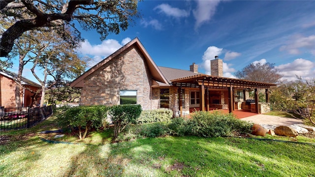 back of house featuring a lawn and a patio