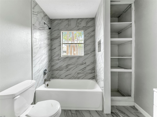 bathroom with tiled shower / bath combo and toilet