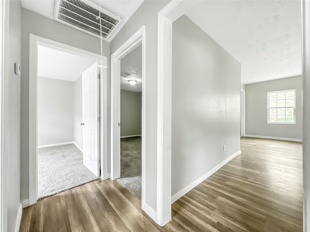 hall with hardwood / wood-style flooring