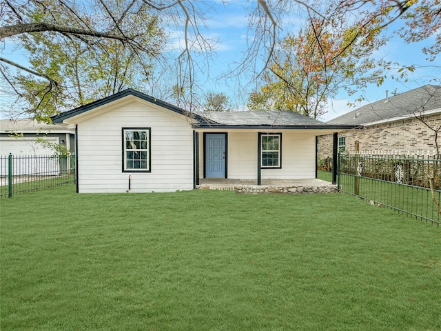 rear view of house featuring a yard