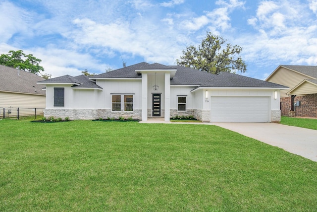 view of front of property featuring a garage and a front yard