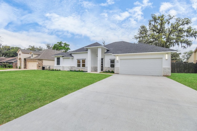 view of front of home with a garage and a front yard