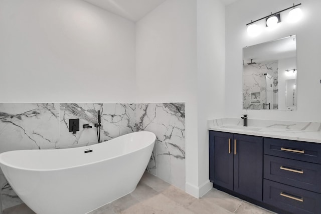 bathroom featuring plus walk in shower, vanity, and tile walls