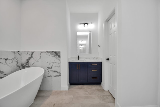 bathroom with a washtub, tile walls, and vanity