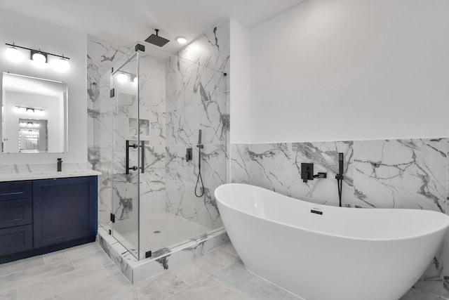 bathroom with vanity, tile walls, and independent shower and bath