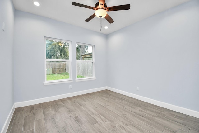 spare room featuring ceiling fan and light wood-type flooring