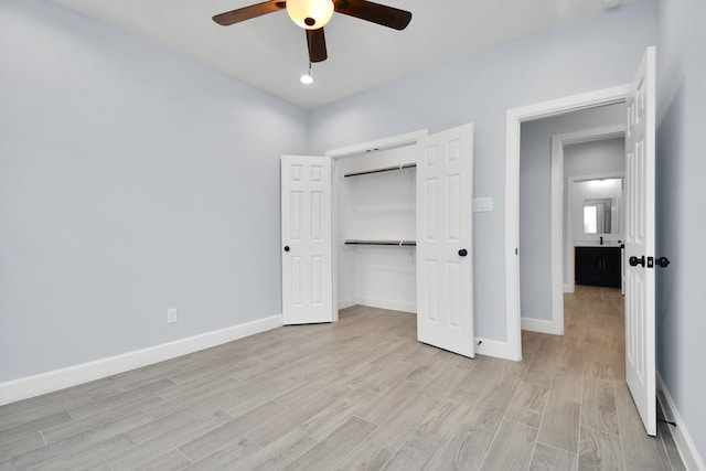 unfurnished bedroom with ceiling fan, a closet, and light wood-type flooring