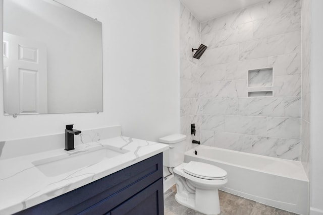 full bathroom featuring vanity, tiled shower / bath combo, and toilet