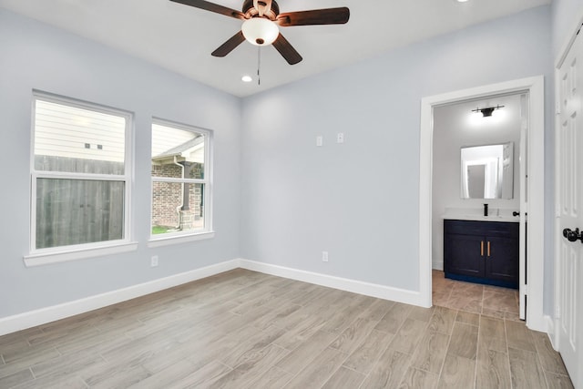 unfurnished room featuring ceiling fan and sink