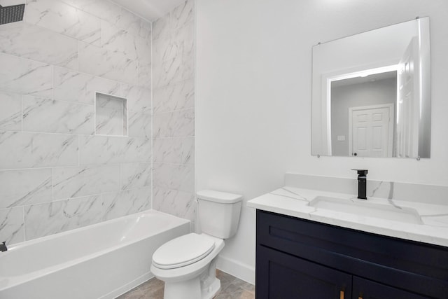 full bathroom featuring vanity, tiled shower / bath combo, and toilet