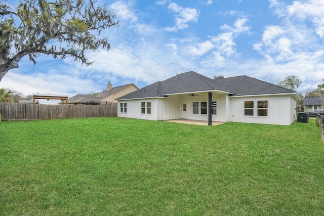 back of property featuring ceiling fan, a yard, and a patio