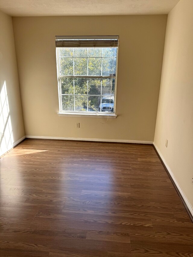 empty room with dark hardwood / wood-style floors