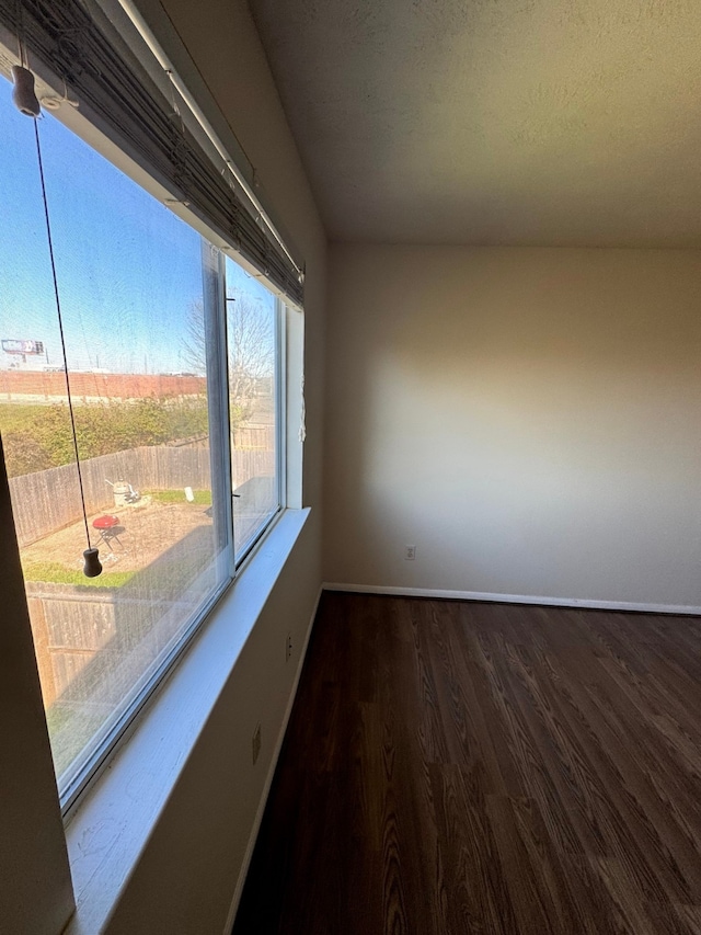 unfurnished room with dark hardwood / wood-style floors