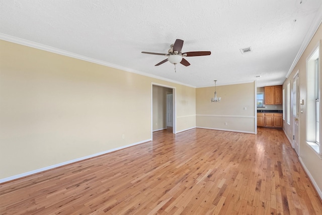 unfurnished room with ceiling fan with notable chandelier, ornamental molding, a textured ceiling, and light hardwood / wood-style flooring