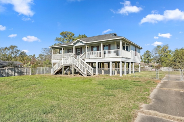 back of house featuring a lawn and covered porch