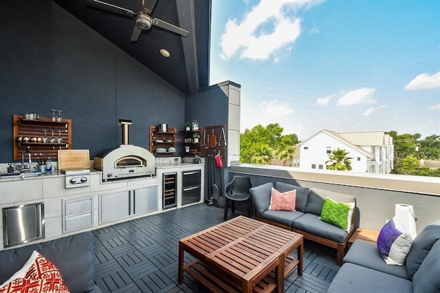 view of patio with area for grilling, outdoor lounge area, sink, and wine cooler