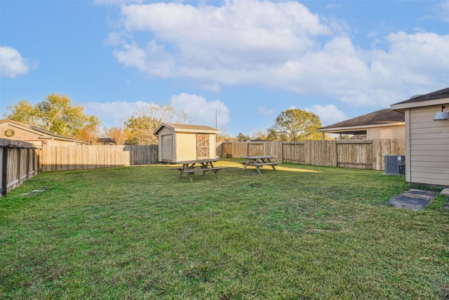 view of yard with central AC and a storage unit